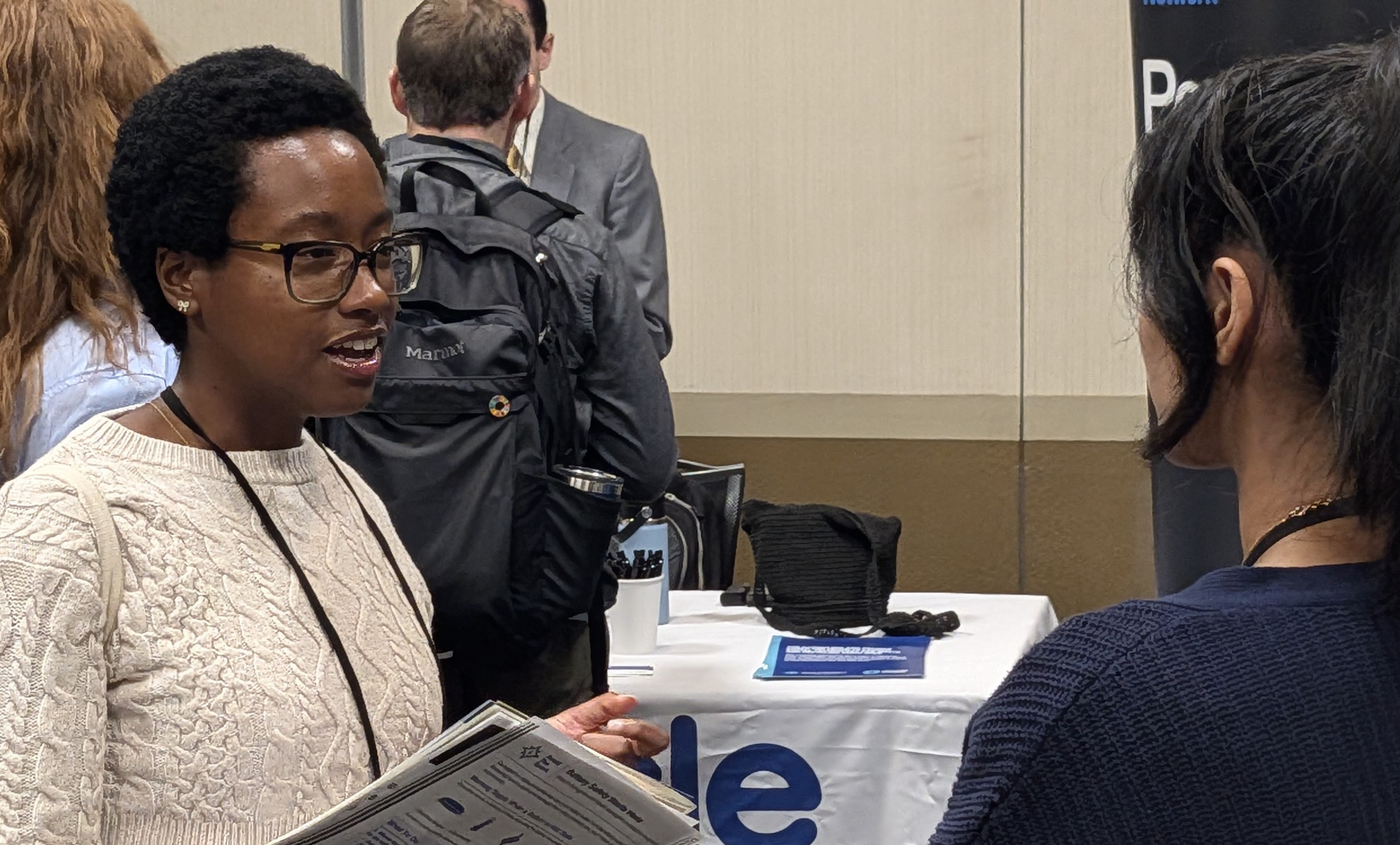 Briana Moore talking in the ICC 2026 exhibition area